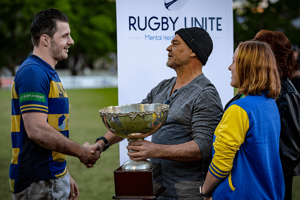 Easts skipper Tom Milosevic accepts the Rick Tyrrell Cup. Photo: QRU Media/Brendan Hertel. 