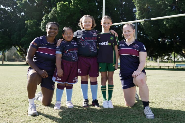 Junior girls from the Norths and Wests clubs launch the Play Your Own Way program with Queensland Reds players Renae Nona (left) and Carys Dallinger at Wests Rugby Club.