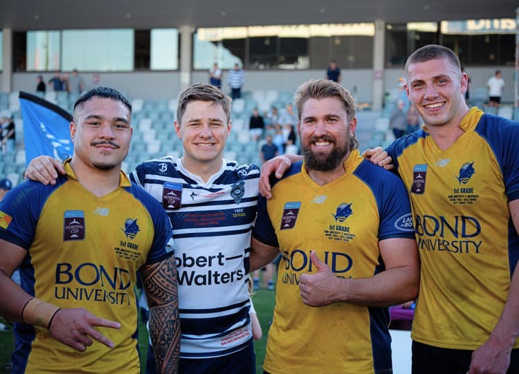 Reds at Bond University (from left) George Blake, Aidan Ross and Josh Canham celebrate while Brothers centre Josh Flook tries to hide the sting of grand final defeat