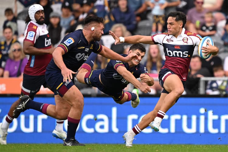 Standout Reds halfback Kalani Thomas scoots clear against the Highlanders in Dunedin