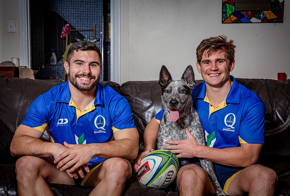 Housemates Jordan Luke, Nick Chapman and their dog Max. Photo: QRU Media/Brendan Hertel