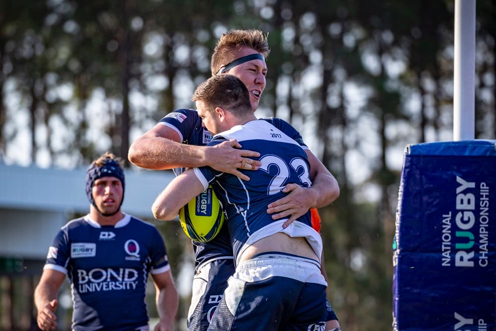 Bond University Queensland Country lock Angus Blyth celebrates Patrick James' try. Photo: Brendan Hertel/QRU