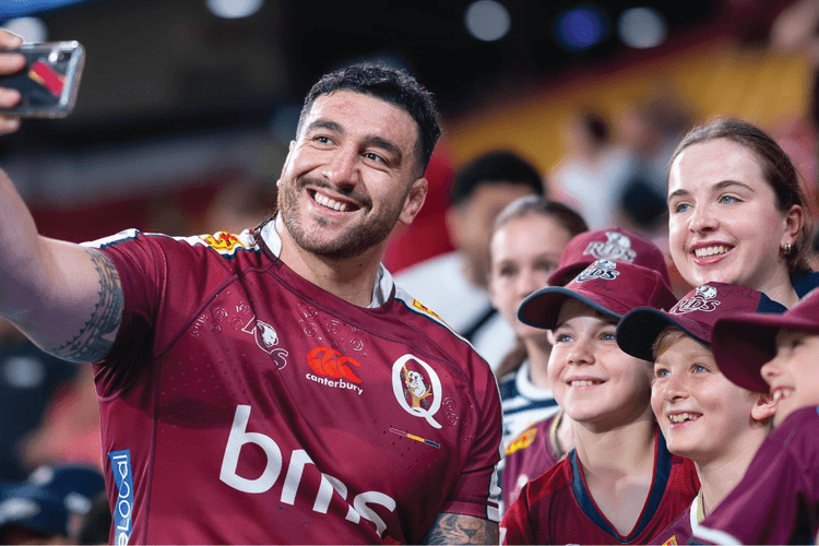 Reds prop Jeffery Toomaga-Allen interacts with fans after a game at Suncorp Stadium.