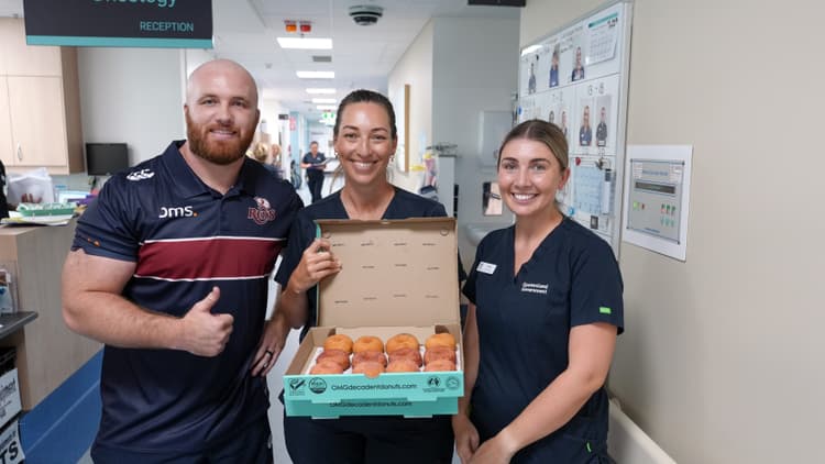 Donut delivery...Reds prop Matt Gibbon delivering treats to nurses at Royal Brisbane and Women's Hospital. Photos: Neha Kumar