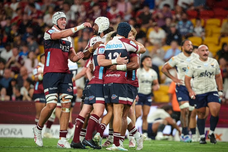 Reds teammates swamp Filipo Daugunu after his try tonight against Moana Pasifika