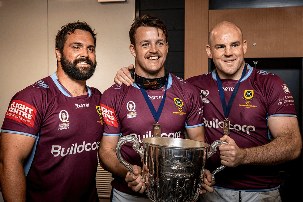 Cam Flavell celebrates UQ's 2021 Hosptial Cup with James Hanson and Stephen Moore. Photo: QRU Media/Brendan Hertel. 