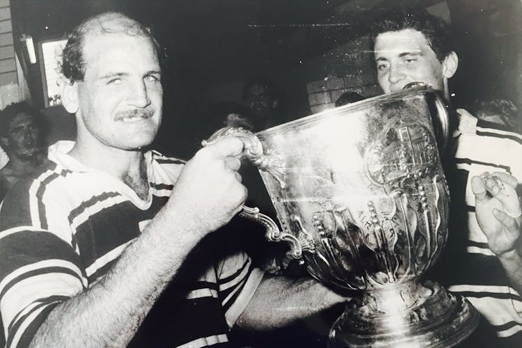 Brothers talisman Tony Shaw holding aloft the Hospital Cup silverware after a premiership in the 1980s.