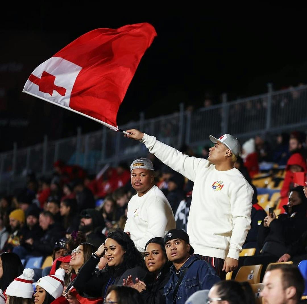 Tonga supporter waves a flag