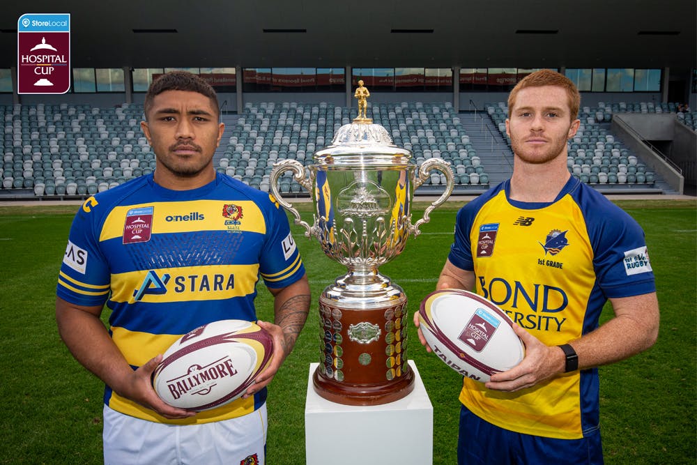 Easts hooker Richie Asiata and Bond University scrumhalf Spencer Jeans pose with the Hospital Cup Trophy. Image: QRU Media